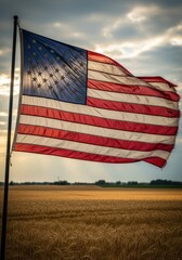 Worn American Flag Waving Over Wheat Field at Sunset