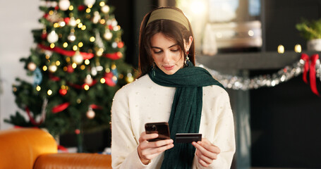 Woman, reading and phone with credit card on Christmas for online shopping, gift search and...