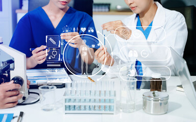 Medical scientists collaborate in a modern lab, using AI and digital holograms to analyze data,...