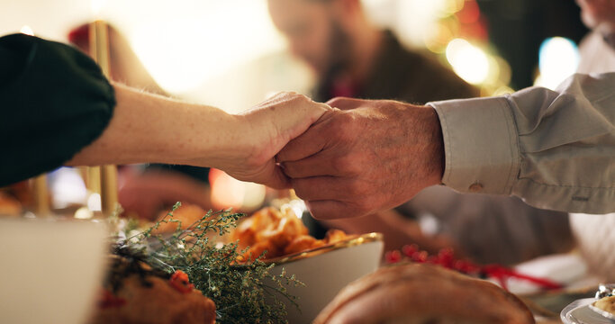 Holding hands, Christmas and prayer with family at dinner table for gratitude, holiday season and love. Worship, spiritual and support with closeup of people in home for festive celebration and trust - Powered by Adobe