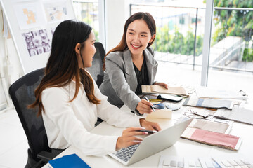 Two women interior designer choosing fabrics,colour paint ,floor finishing for home decoration.