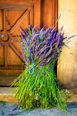Freshly cut lavender bundle on an old wooden door - Natural charm and Mediterranean flair in...