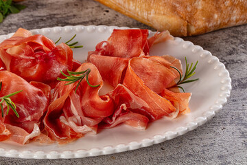 Spanish dry jamon serrano pork meat slices