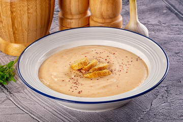 Tasty cheese cream soup with crouton