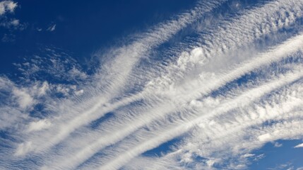 Fototapeta premium Wispy White Clouds Against Deep Blue Sky on a Sunny Day