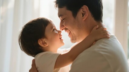 Obraz premium Father and Toddler Embrace in Soft Natural Light
