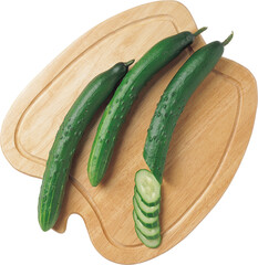 Three whole fresh green cucumbers and a stack of sliced cucumber pieces on a wooden cutting board...