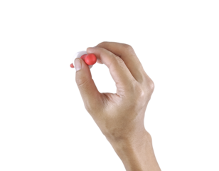 Close-up of a hand gripping a pediatric syrup dropper, commonly used for child medication