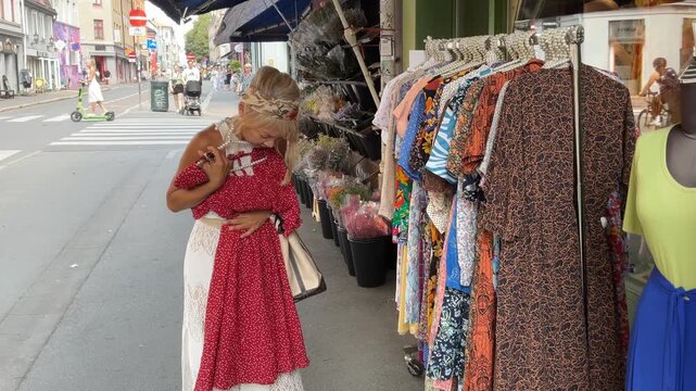 woman shopping for a dress in a small business in an urban neighborhood in Oslo, Norway