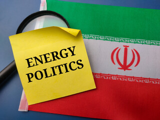 Closeup stickey note with the word ENERGY POLITICS on a iran flag background