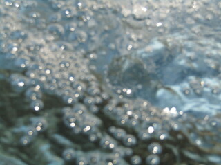 Abstract view of bubbling water in clear natural stream