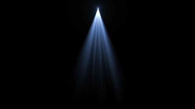 A single spotlight shines brightly downwards, illuminating a dark space, creating a visual focus.