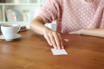 Woman hand giving you a business card