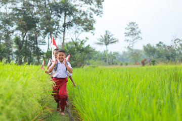 Cheerful Elementary Student Boys In Uniform Holding Indonesia Flags And Patriotism In Nature