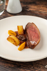 Gourmet roasted duck breast served with root vegetables and sauce