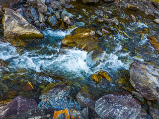 Flowing mountain stream with rocks in serene nature