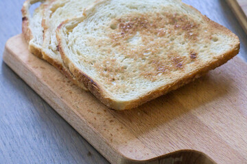 Golden brown toast served on a wooden cutting board in a cozy kitchen setting
