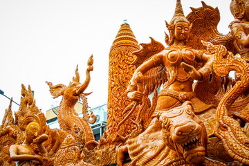 Buddhist Lent tradition, a beautiful display of wisdom, beeswax candles create art as a Buddhist offering.Background with Thai pattern carved on the surface of a Buddhist Lent candle.Ubon Ratchathani.
