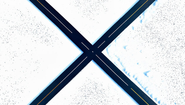 Aerial drone view of black X-shaped road intersection in snowy landscape, geometric symmetry, clear blue sky - Powered by Adobe