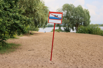 Cautionary Warning Sign Present at Sandy Beach that is Located Near the Water Body Area