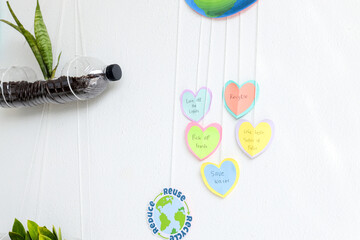 White Wall Decorated With Environmental Messages And Recycled Plant Life