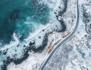 High-angle view of a winding road bordering a wintry coastline