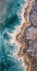 Aerial view of a coastal landscape, showing a vibrant mix of teal water and ochre-toned earth