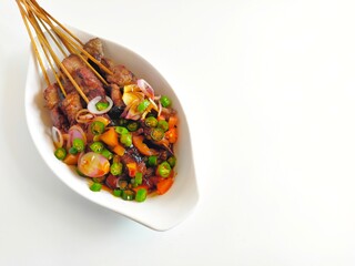 Satay or Sate Kambing, meat satay served with slice red onion, ​​chili, ​​tomatoes with soy...
