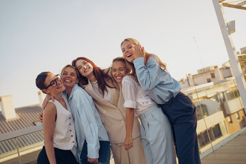 A Joyful Group of Friends Smiling Together, Making Memories Outdoors at Beautiful Sunset