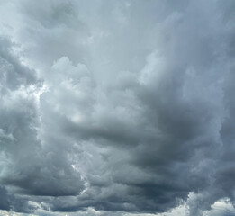 Stormy sky with dark, snowy clouds on a spring day. Clouds are floating across the sky. Dark blue...