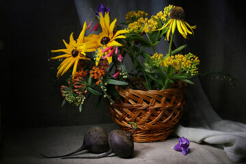 Floral background with a bouquet of different flowers in a basket