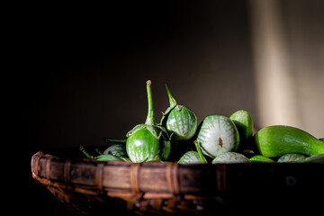 Piles of eggplants from the garden harvest in low light