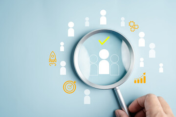 Human resource management in business magnifying glass focusing on selected candidate among team,...