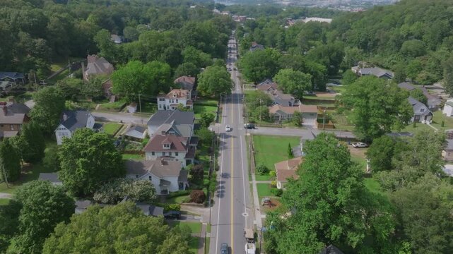 Aerial view of a tree-lined street running through St. Elmo, Chattanooga, with historic homes and dense greenery on both sides.