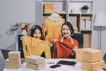 Portrait of Starting small businesses SME owners, two Asian woman check online orders Selling...
