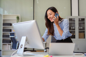 Business women talk mobile phones update tasks with milestones progress planning while working on...
