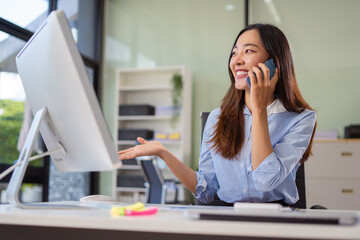 Asian businesswoman involved in cellphone call conversation giving professional consultation to client or negotiating project.