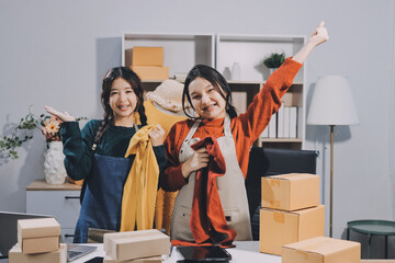 Portrait of Starting small businesses SME owners, two Asian woman check online orders Selling...