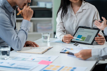 Fototapeta premium Businessmen write project ideas and use laptops to edit papers for brainstorming sessions with partners in the office.