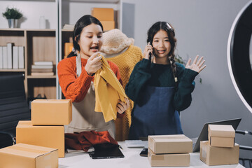 Portrait of Starting small businesses SME owners, two Asian woman check online orders Selling...