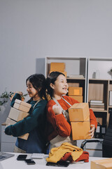 Portrait of Starting small businesses SME owners, two Asian woman check online orders Selling...