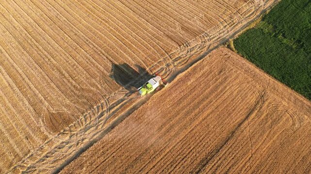 Agriculture hay mower tedder tractor modern field work rural village, aerial drone