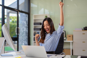 Excited woman work distant on computer talk on cellphone celebrate online win. Happy young female...