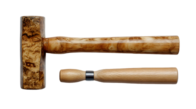 A wooden mallet and a wooden handle with a metal ring on a black background in a studio shot