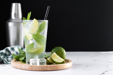 Classic Mojito Cocktail with Lime and Mint on black background. Copy space