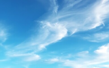 Fototapeta premium A vibrant blue sky is filled with soft, wispy white clouds creating a serene and peaceful atmosphere, perfect for background.