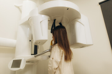 Young girl undergoing dental panoramic radiography in modern clinic