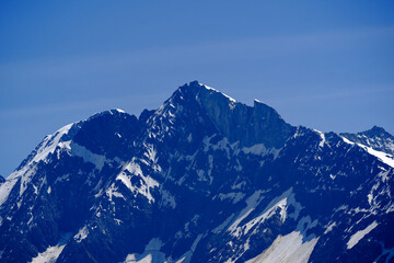 Doing hiking with mountain panorama in the Swiss Alps at Lötschental Valley on a sunny late spring...