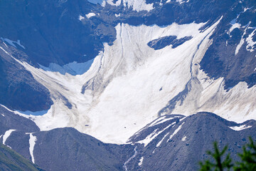 Doing hiking with mountain panorama in the Swiss Alps at Lötschental Valley on a sunny late spring...