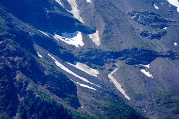 Doing hiking with mountain panorama in the Swiss Alps at Lötschental Valley on a sunny late spring...